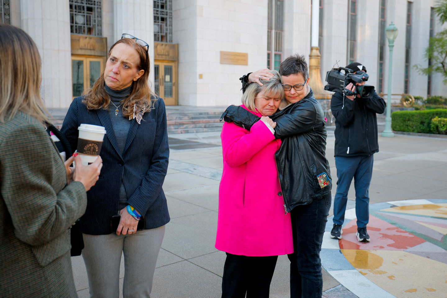 A woman embraces Lori Schott from Colorado, one of the parents who say they lost their children because of social media, outside a court house in Los Angeles on Feb. 18.  [REUTERS/YONHAP]